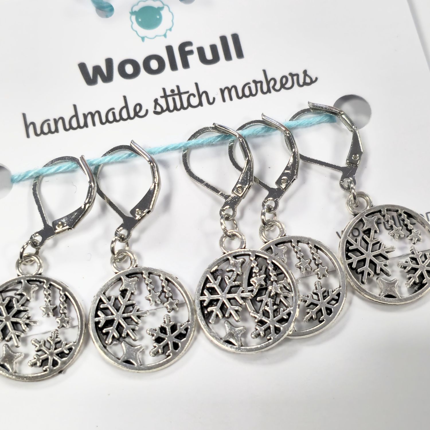 5 silver snow globe stitch markers.