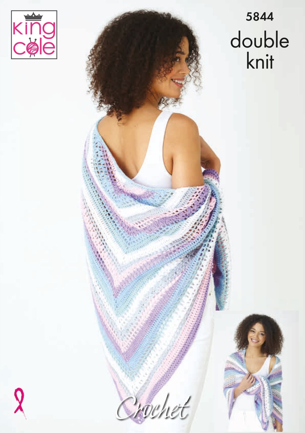A woman is wearing a crocheted shawl in shades of white, pink, purple and blue.