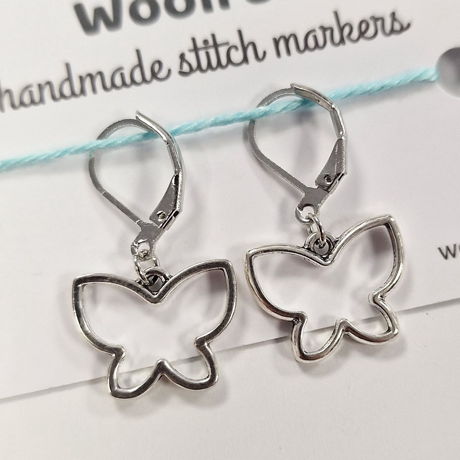 2 silver metal butterfly shaped stitch markers.