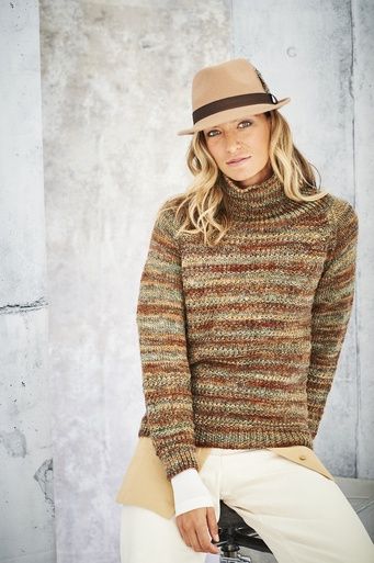 A woman is wearing a knitted sweater in a variegated brown yarn.