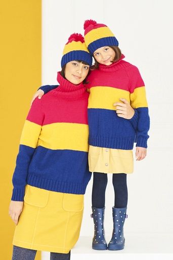 A woman and a girl are wearing matching knitted sweaters and hats in red, yellow and navy blue stripes.