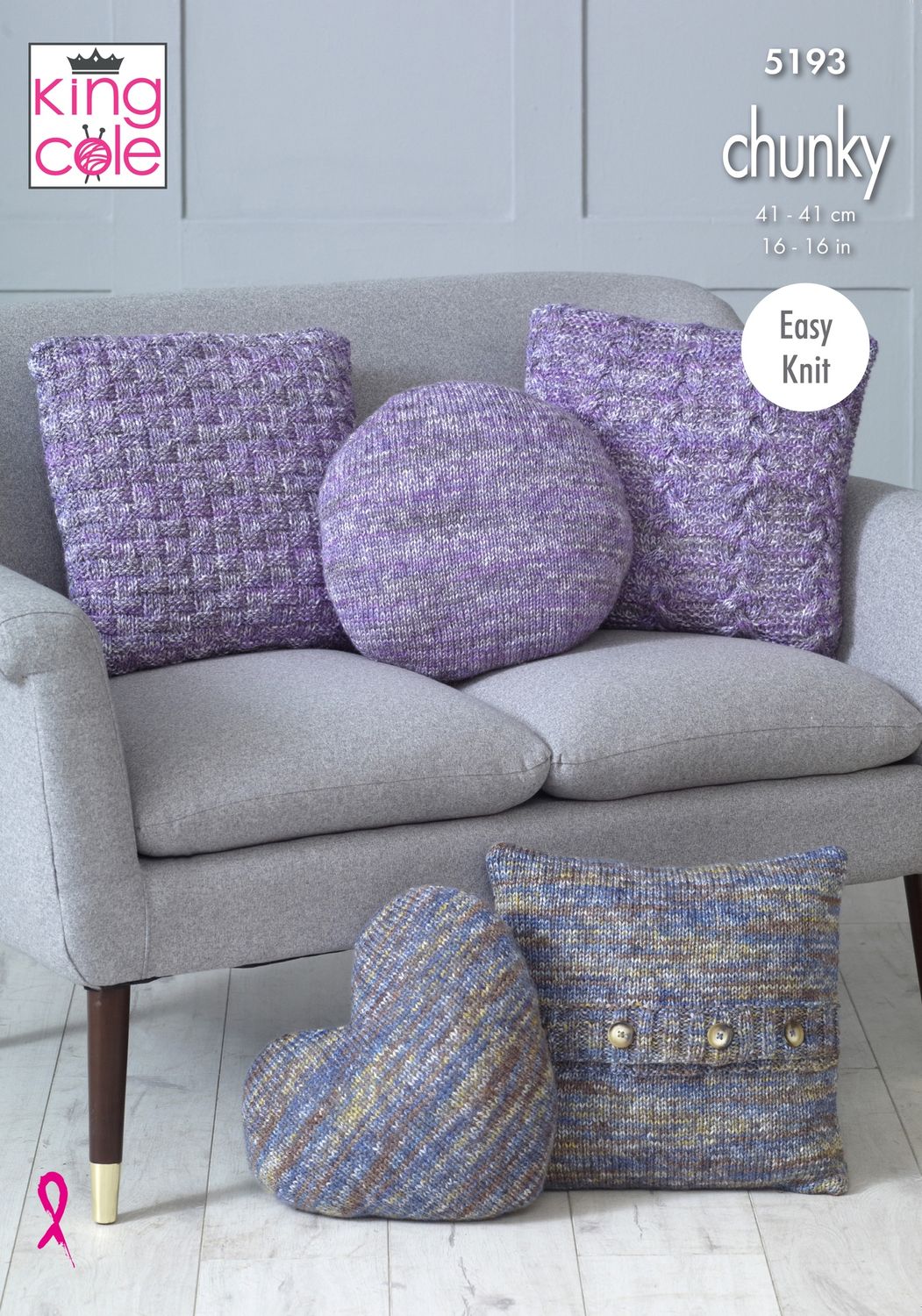 Several knitted cushions, some in a variegated purple yarn and some in a variegated blue and grey yarn.