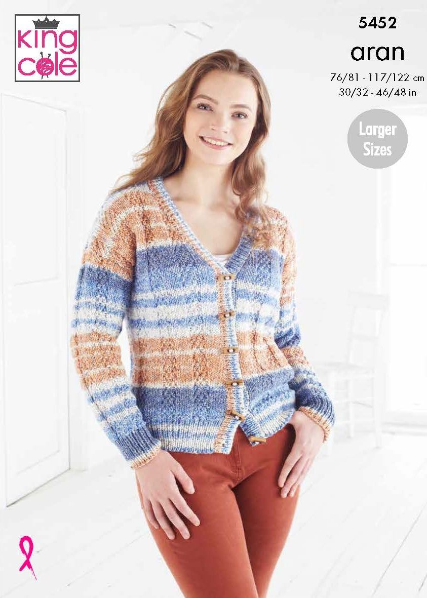 A woman is wearing a knitted cardigan in a variegated blue and brown yarn.