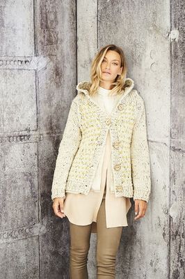 A woman is wearing a cream knitted cardigan.