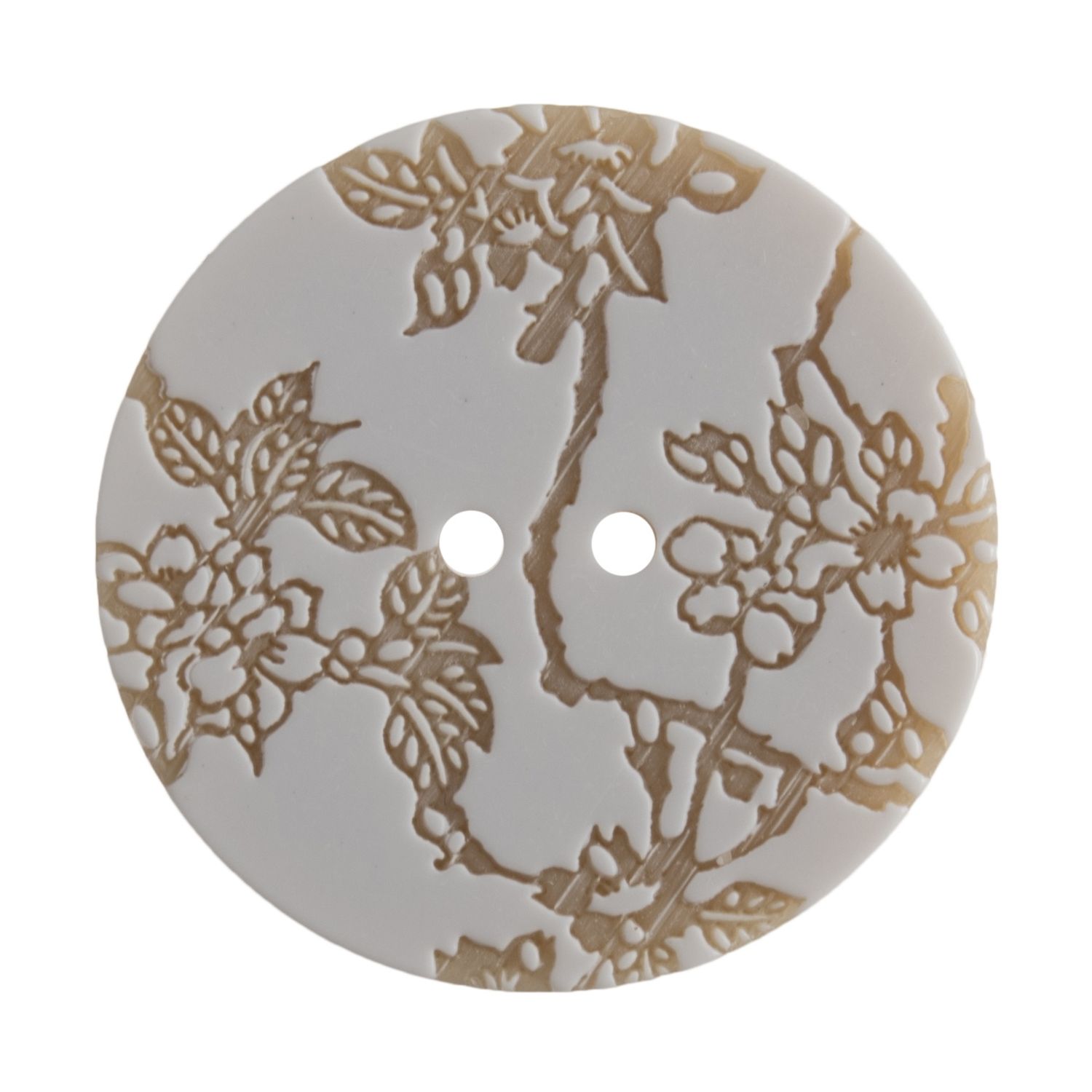 A round button with a brown and white engraved flower design.