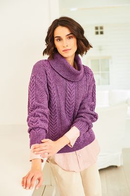 A woman is wearing a purple polo neck knitted sweater.