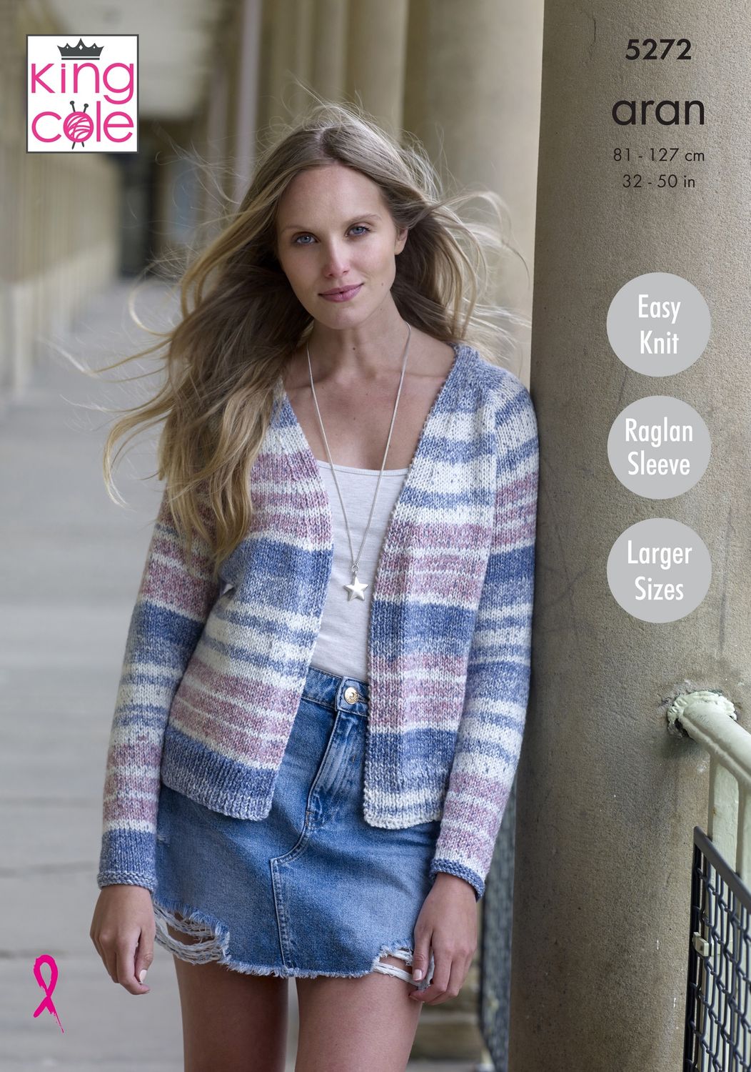 A woman is wearing a knitted cardigan in a variegated blue, pink and cream yarn.