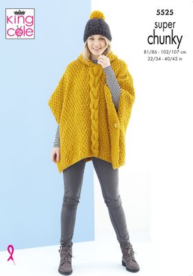 A woman is wearing a mustard knitted poncho and a grey and mustard knitted hat.