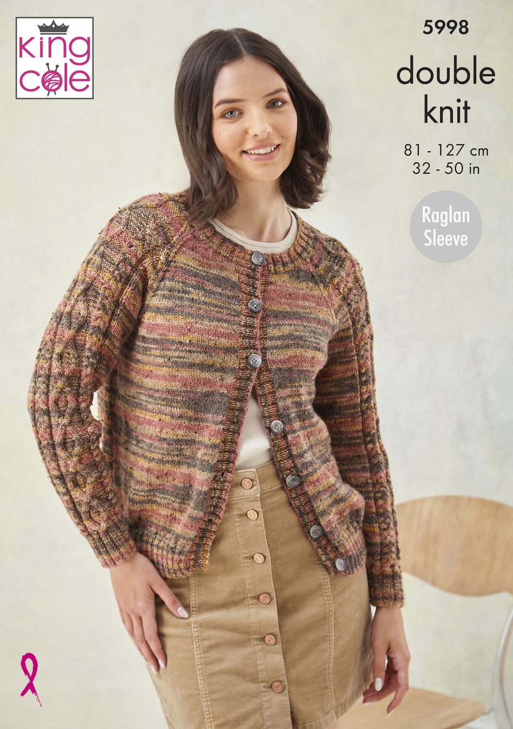 A woman is wearing a knitted cardigan in shades of red, yellow and brown.