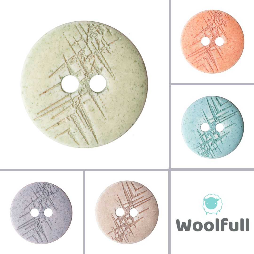 5 round, pastel coloured buttons with random engraved lines.