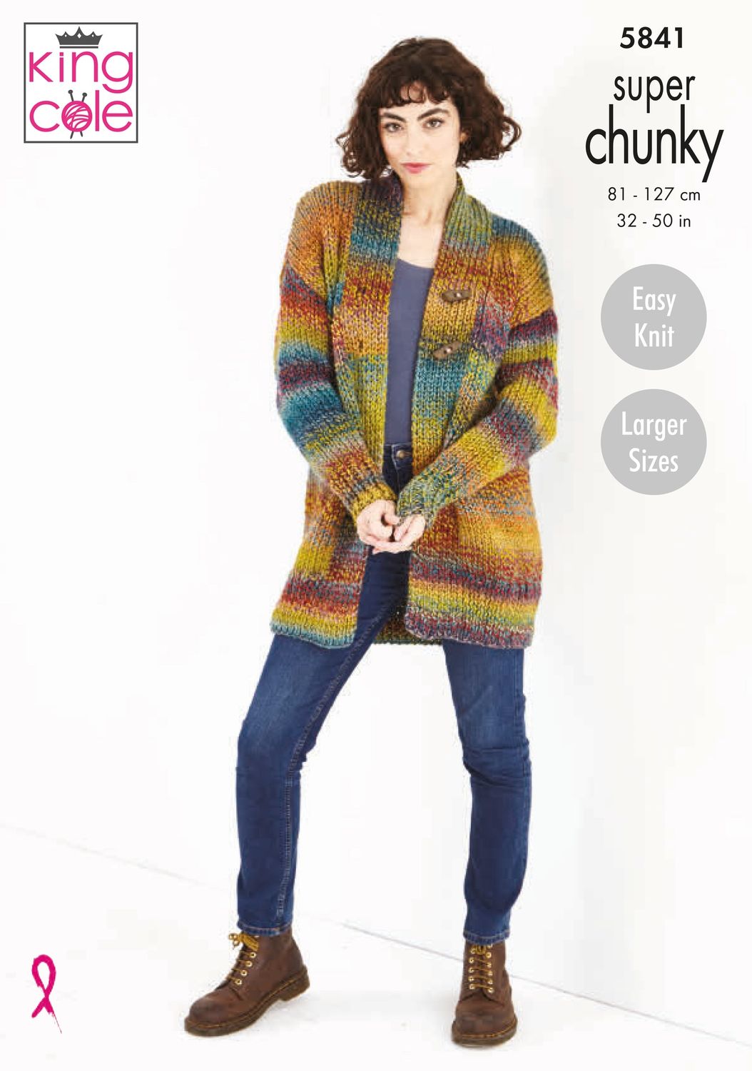 A woman is wearing a chunky knitted cardigan in shades of yellow, blue, purple and red.