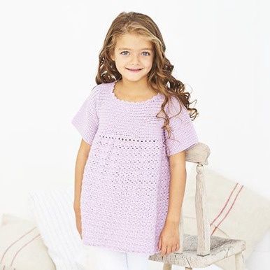 A girl is wearing a purple crocheted dress.