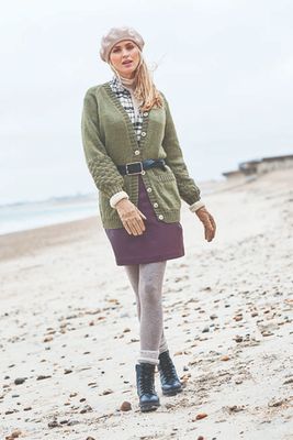A woman is wearing a green knitted cardigan.