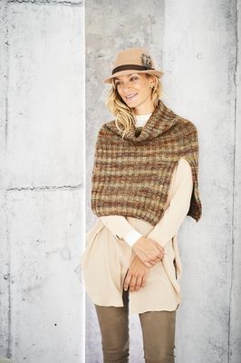 A woman is wearing a knitted cowl in a variegated brown yarn.