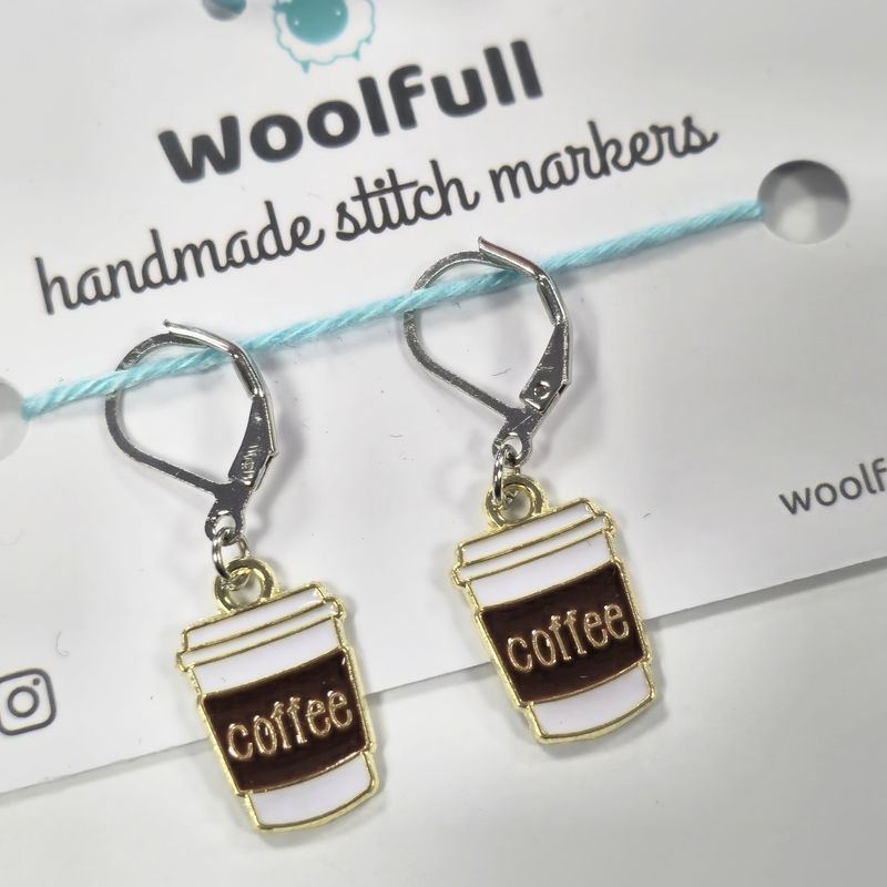 2 white coffee cup shaped stitch markers.