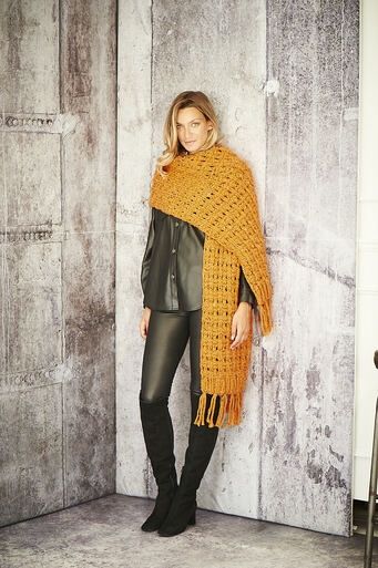 A woman is wearing an orange knitted scarf.