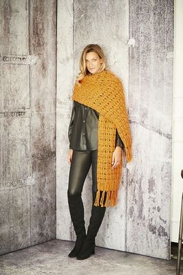 A woman is wearing an orange knitted scarf.