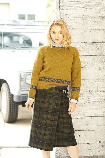 A woman is wearing a lime green knitted sweater.