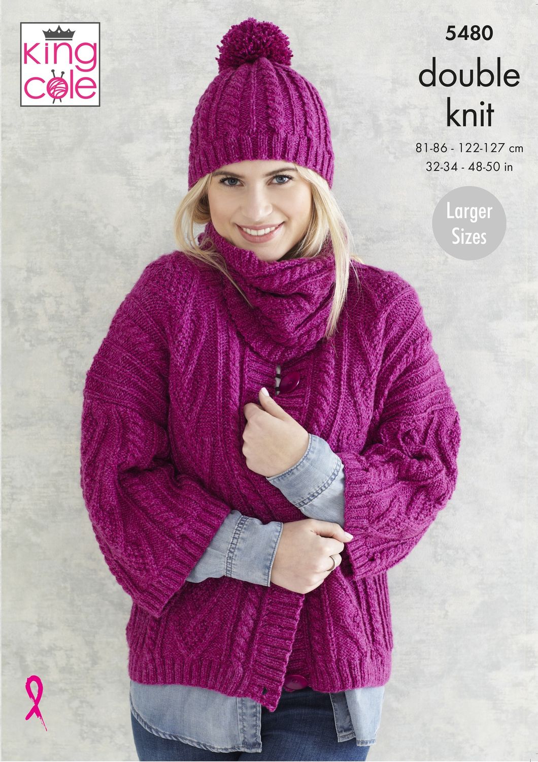 A woman is wearing a fuchsia knitted cardigan with cable detail all over with a matching hat and snood.