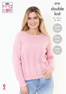 A woman is wearing a pink knitted sweater with lace detail on the bottom half.