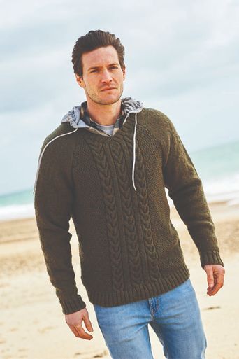 A man is wearing a dark green knitted sweater.