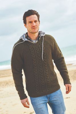 A man is wearing a dark green knitted sweater.