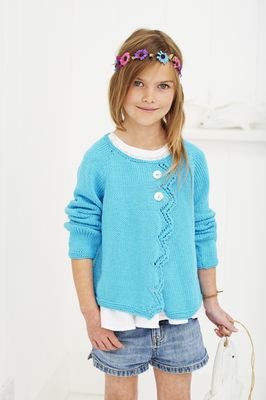 A girl is wearing a bright blue knitted cardigan.