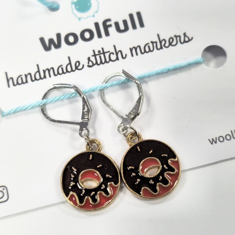 2 brown donut shaped stitch markers.