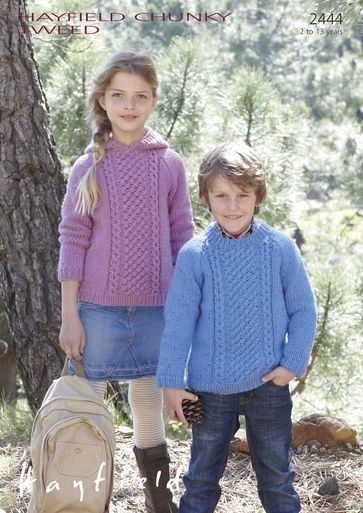 A girl is wearing a purple cable knit sweater, stood next to a boy wearing a blue cable knit sweater.