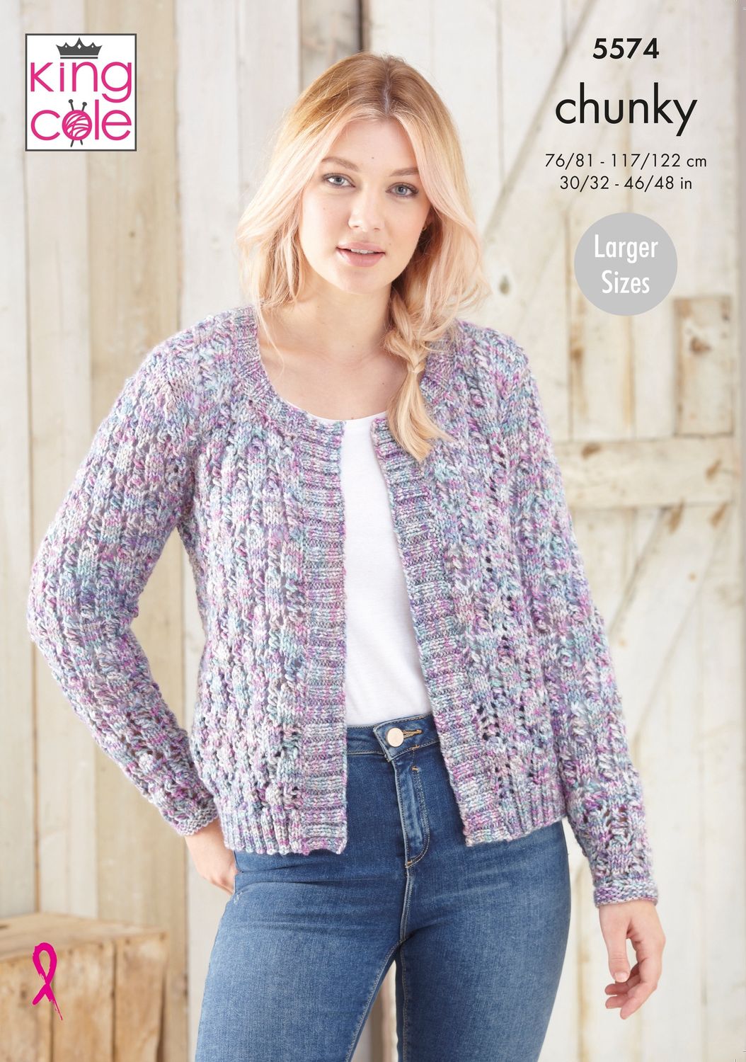 A woman is wearing a knitted cardigan in a variegated purple and pink yarn.