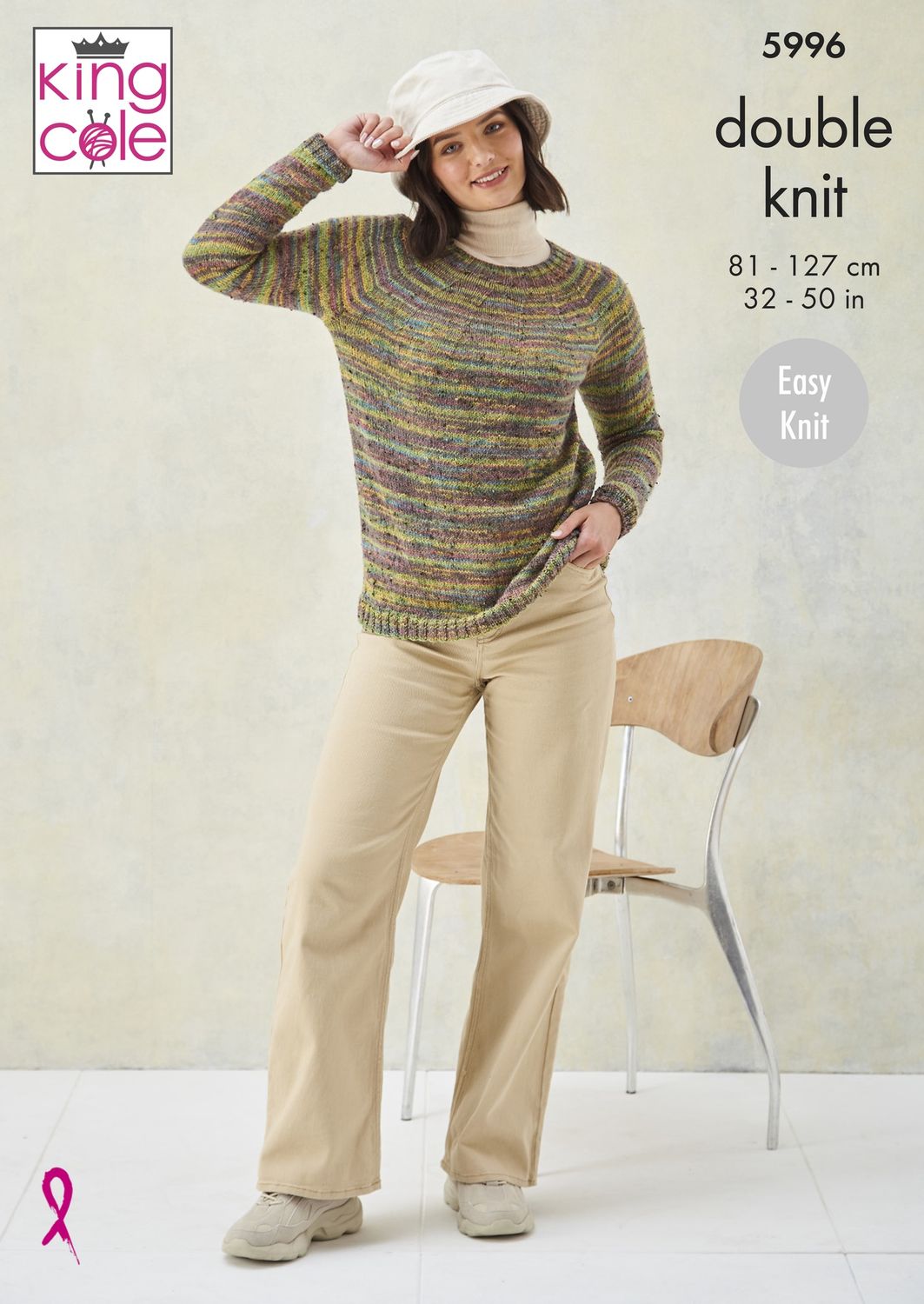 A woman is wearing a knitted sweater in shades of green, yellow, purple and blue.
