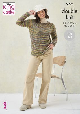 A woman is wearing a knitted sweater in shades of green, yellow, purple and blue.