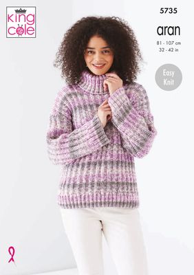A woman is wearing a knitted rib textured sweater in a variegated pink yarn.