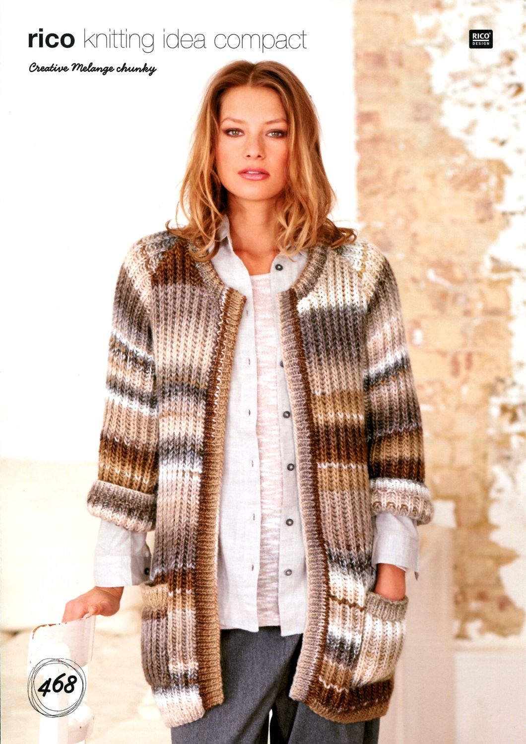 A woman is wearing a knitted cardigan in a variegated cream and brown yarn.