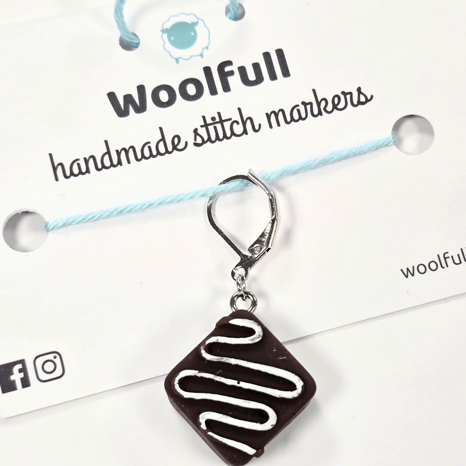 A square chocolate brownie stitch marker.

