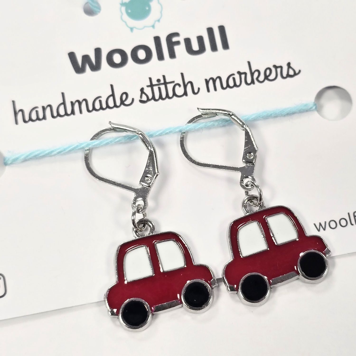 2 red car shaped stitch markers.