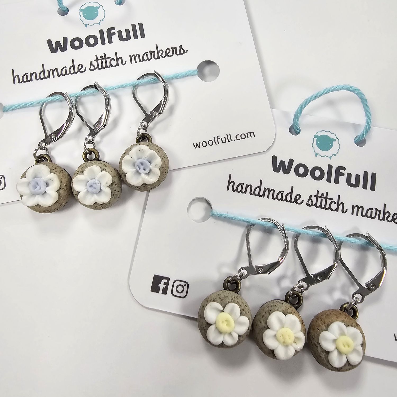 2 packs of 3 ceramic stones topped with flower stitch markers.