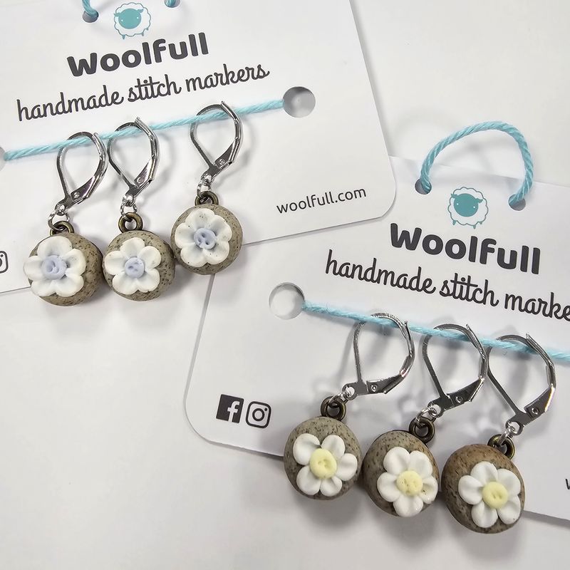 2 packs of 3 ceramic stones topped with flower stitch markers.