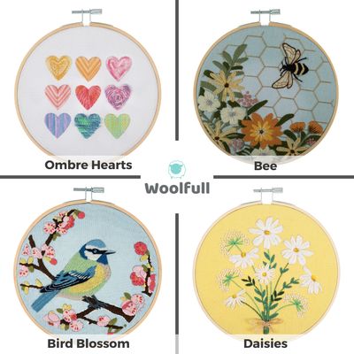 4 embroidery kits, 1 with ombre hearts on a white background, 1 with flowers and a bee on a blue background, 1 with flowers and a bird on a blue background and 1 with daisies on a yellow background.