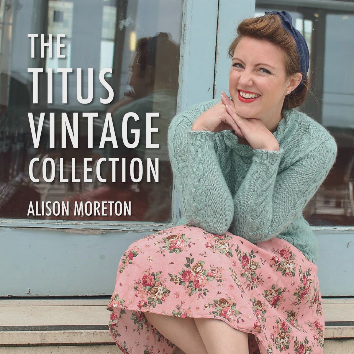 The front cover of the book, showing a blue knitted sweater and the title.