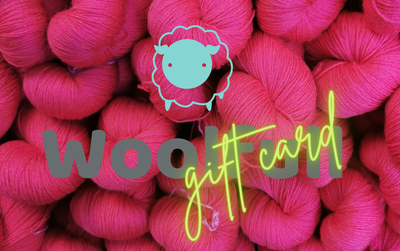A background of bright pink skeins of yarn, with the Woolfull logo and green neon style text that says &#39;gift card&#39;.