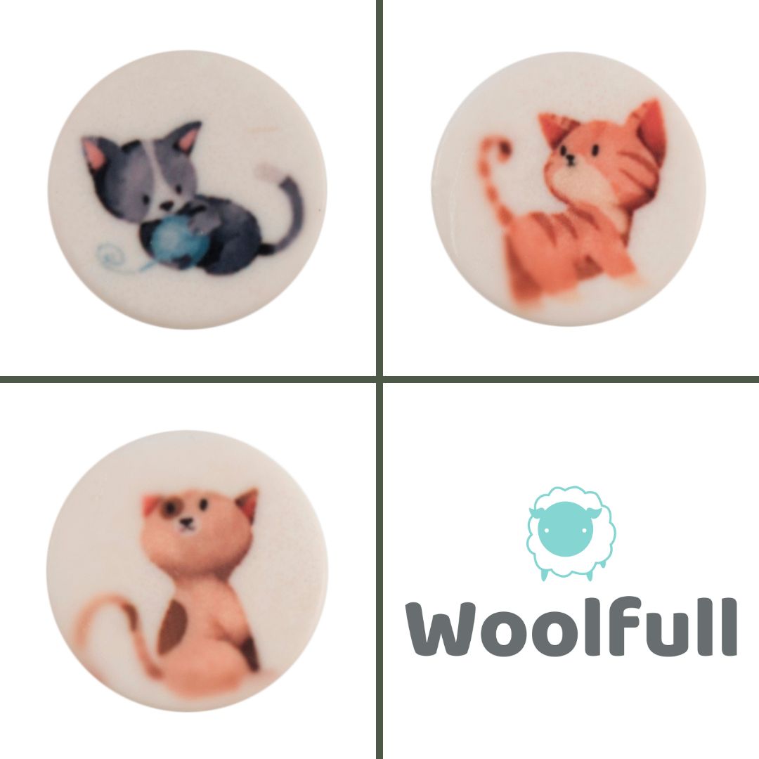 3 round white buttons, each with a cartoon cat design.