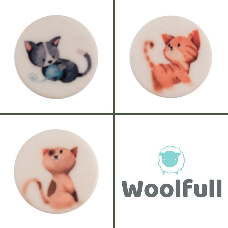 3 round white buttons, each with a cartoon cat design.