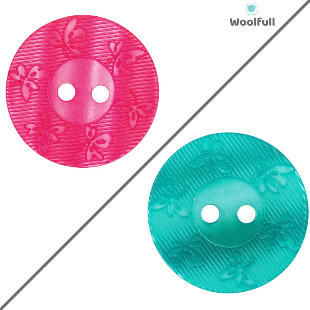 A pink button and a turquoise button, both with a leaf design around the edge.