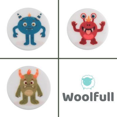 3 round white buttons, each with a cartoon monster design.