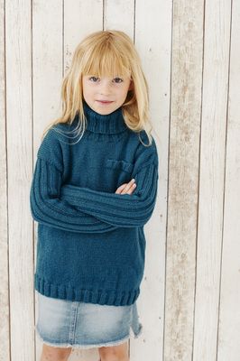 A girl is wearing a dark teal knitted sweater.