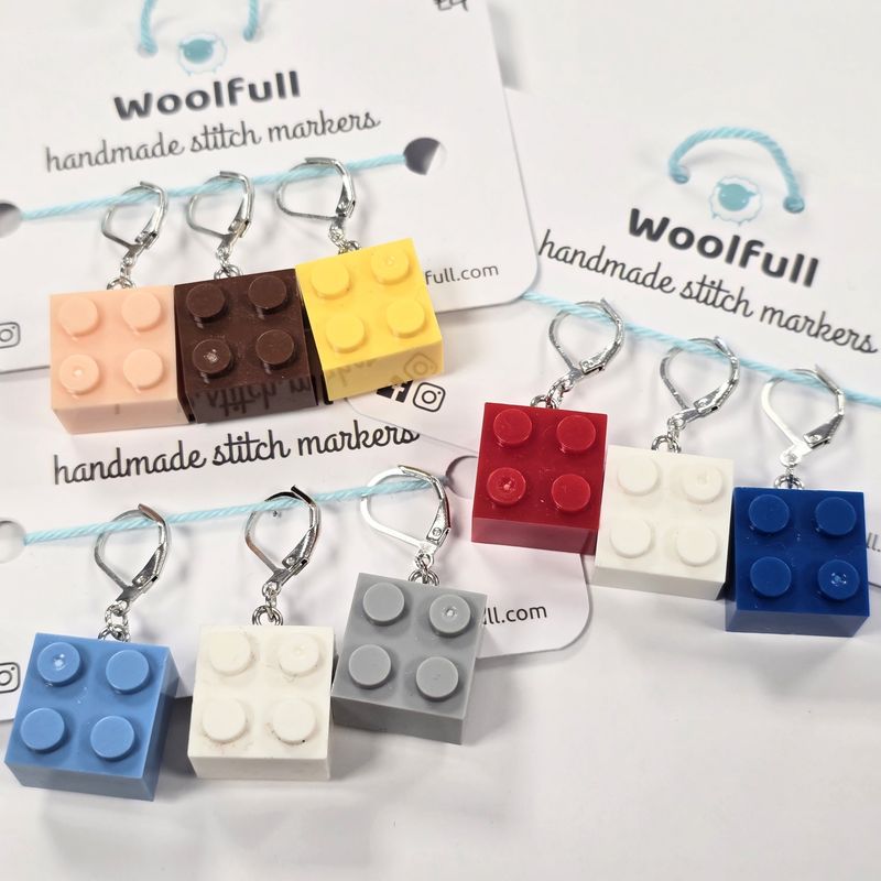 3 packs of stitch markers, each with 3 brightly coloured building block stitch markers.

