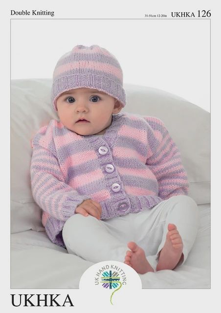 A baby is wearing a knitted pink and purple striped cardigan and matching hat.