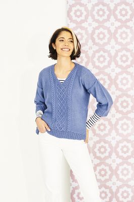 A woman is wearing a denim blue knitted sweater.