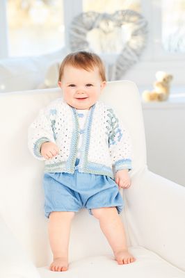 A baby is wearing a variegated blue crocheted cardigan.